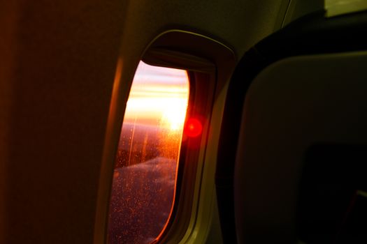 View from an airplane window at sunset