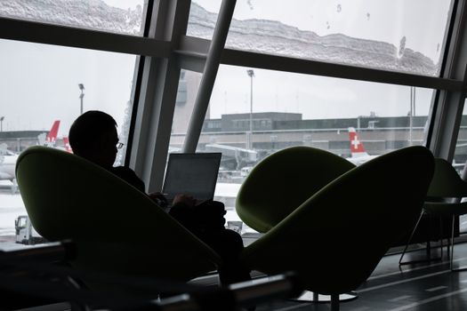 Business traveller using an airport lounge